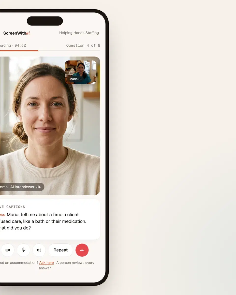 The interview on a phone: Emma on screen, Maria in the corner, live captions underneath